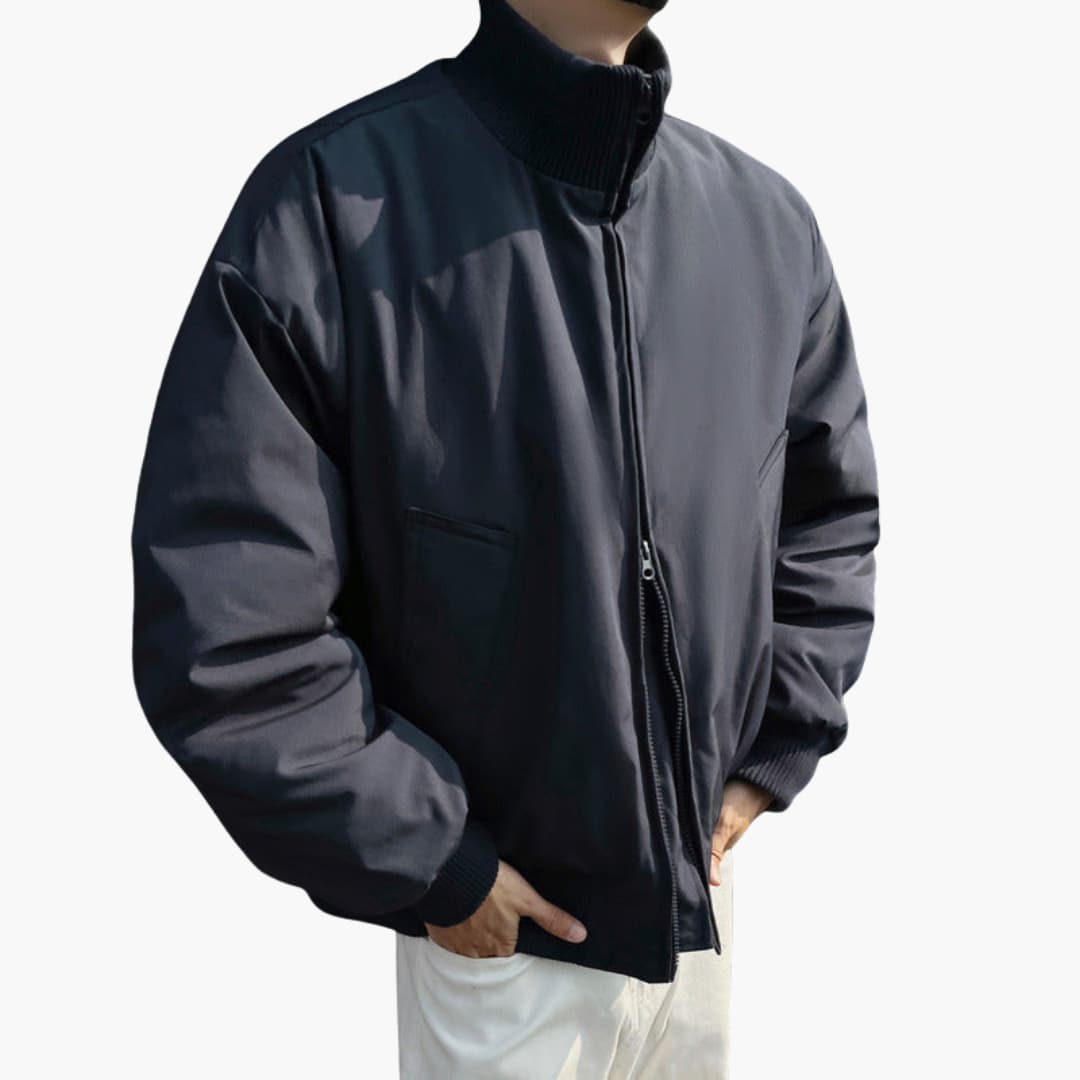 Men’s bomber jacket in black with a high ribbed collar, front zipper, and side pockets.