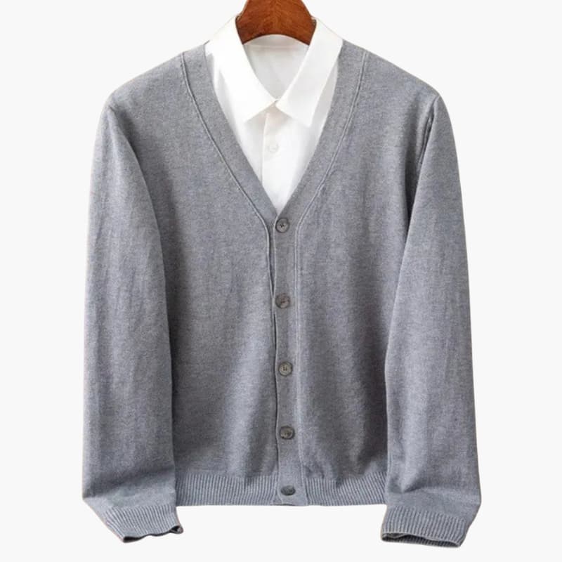 Men’s cardigan, grey knit with a V-neck and button closure, shown over a white shirt on a hanger