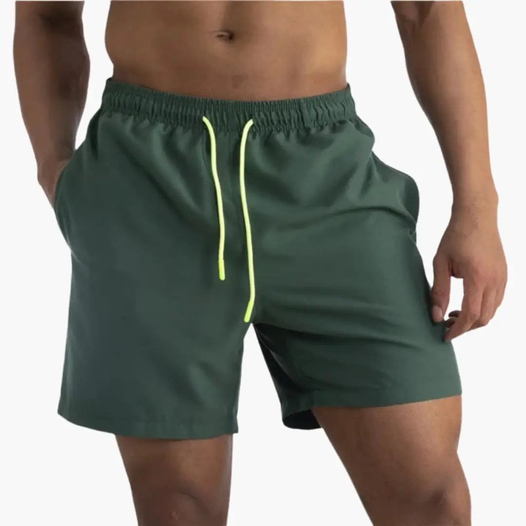 Wilfred Smith Men's jogger shorts in dark green with elastic waistband and neon-yellow drawstring.