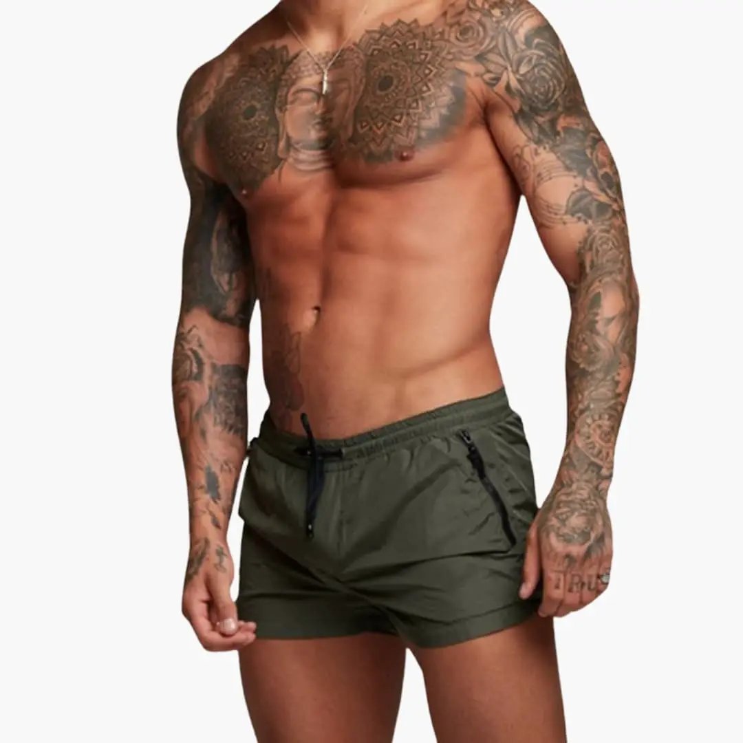 Men's jogger shorts in olive green with elastic waistband and zippered pockets, Wilfred Smith.