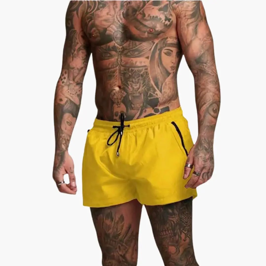 Men’s jogger shorts in bright yellow with elastic waistband, black drawstring and zippered pockets