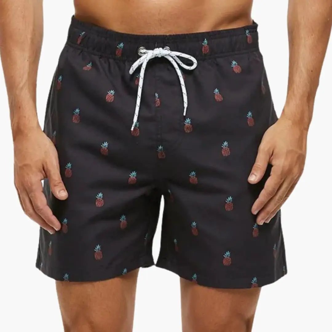 Men’s swim shorts in black with elastic waistband and white drawstring, pineapple print