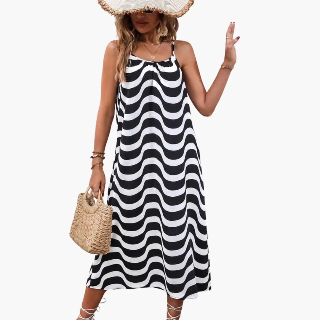 Women’s beach dress with spaghetti straps in black and white wave pattern.