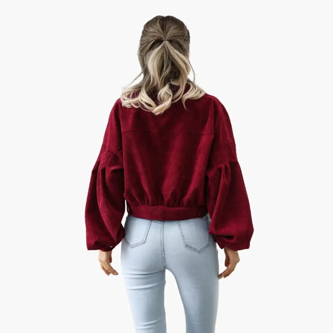 Women's bomber jacket in burgundy velvet with zipper and pockets, back view.
