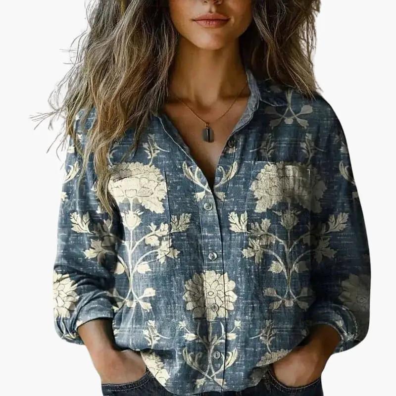 Women's button-down shirt in blue denim with beige floral print, classic collar, and long sleeves