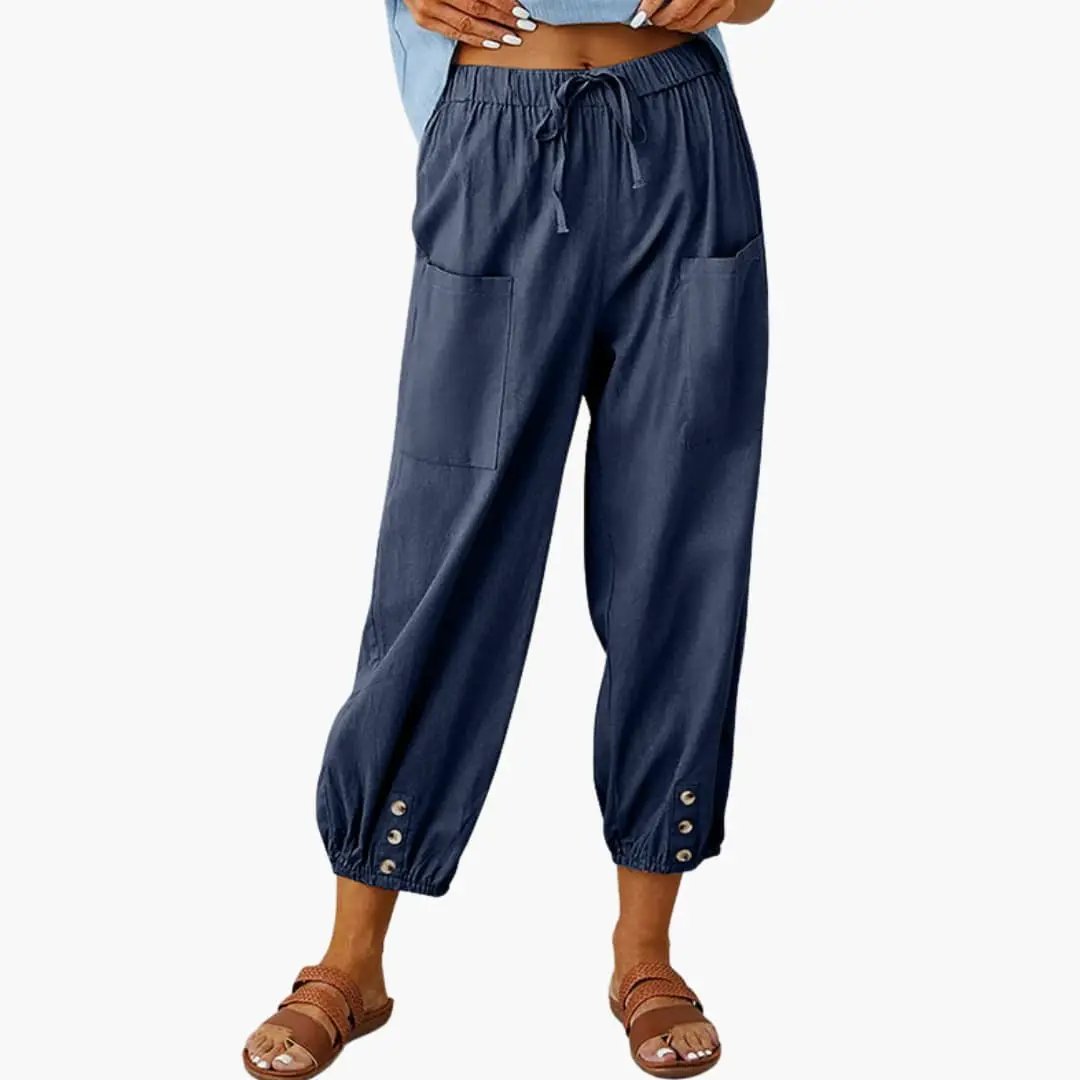 Women's casual pants with drawstring waist, navy blue, side pockets, and elastic cuffs with metal buttons.