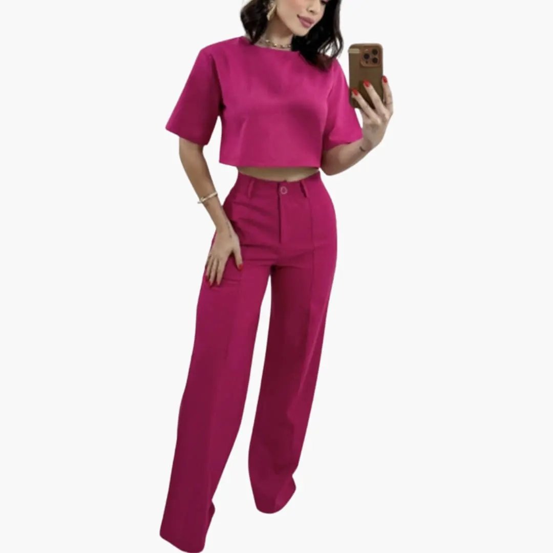 Women's two-piece outfit with cropped magenta top and high-waisted wide-leg trousers