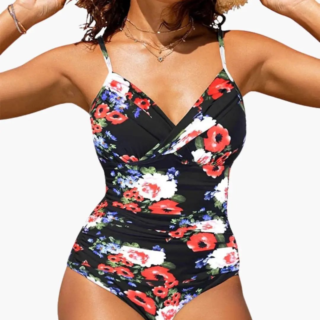 Women’s cross-front backless one-piece swimsuit in black floral print by Wilfred Smith.