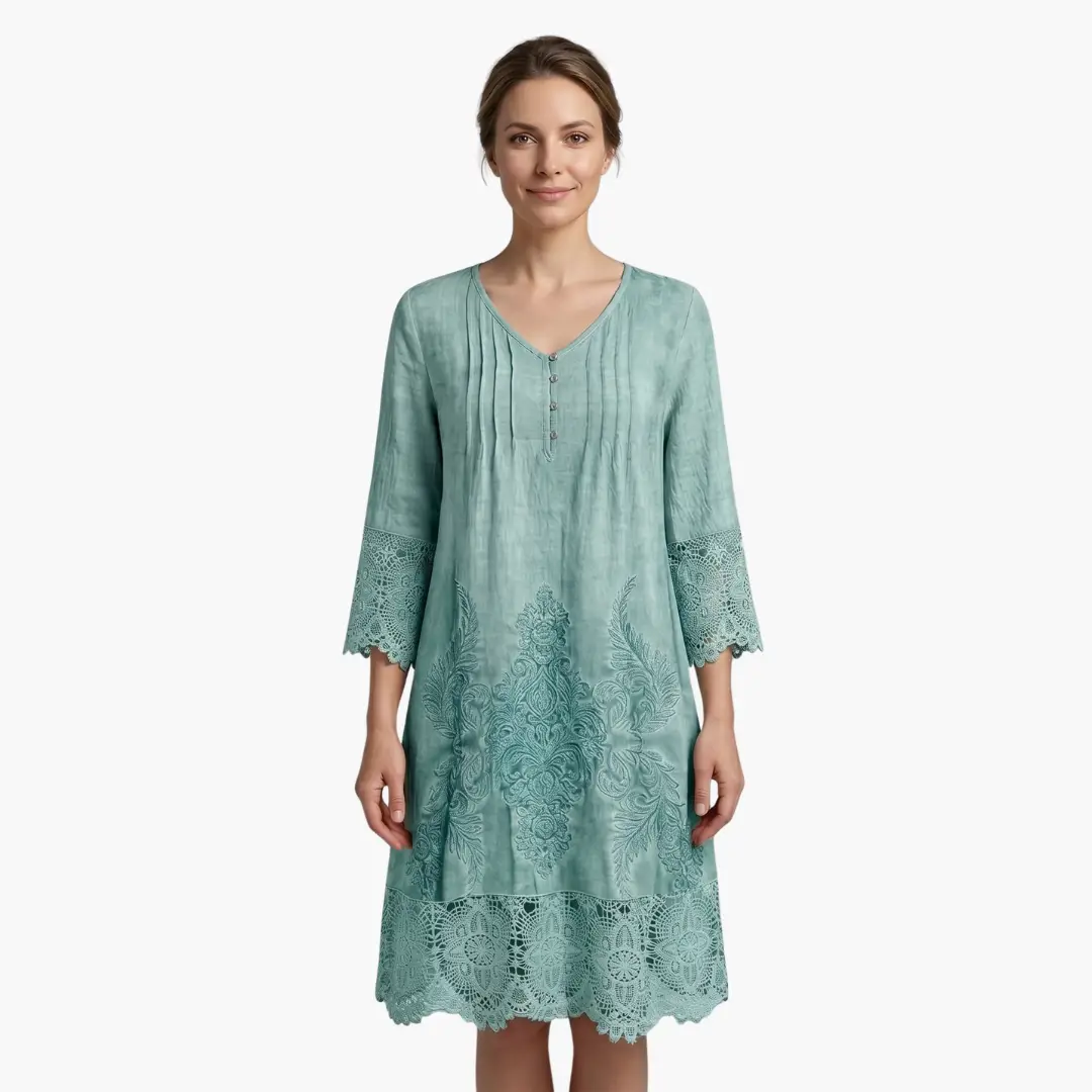 Women’s embroidered midi dress by Wilfred Smith in seafoam teal with scalloped lace hem.