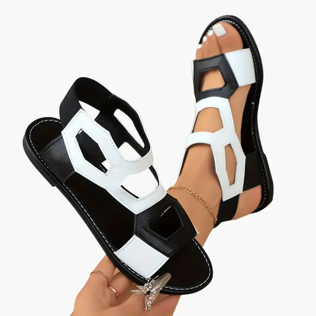 Women's flat sandals with cushioned sole, black and white color-block straps, strap fastening