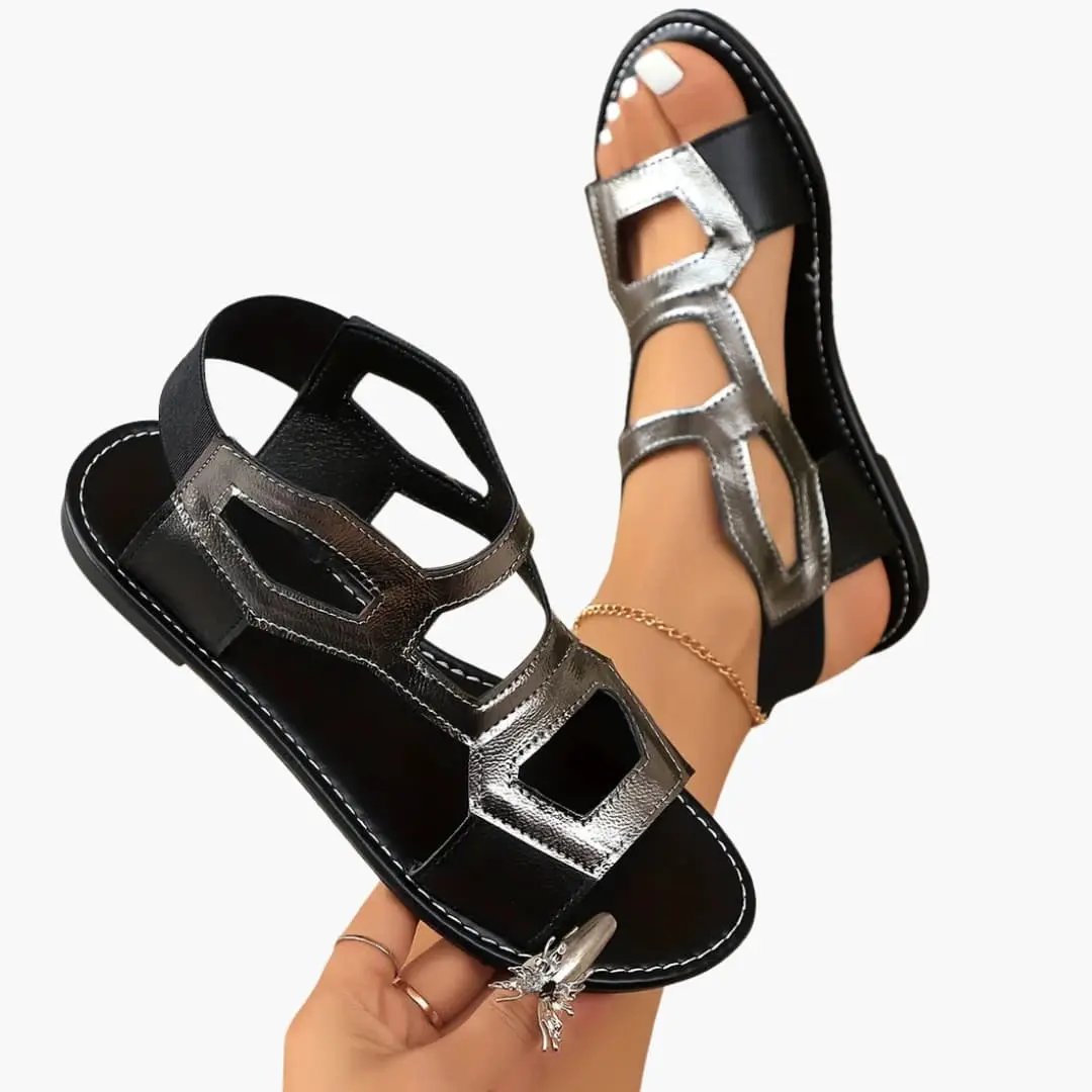 Women's flat sandals; pair shown with cushioned soles, black bases and metallic silver straps.