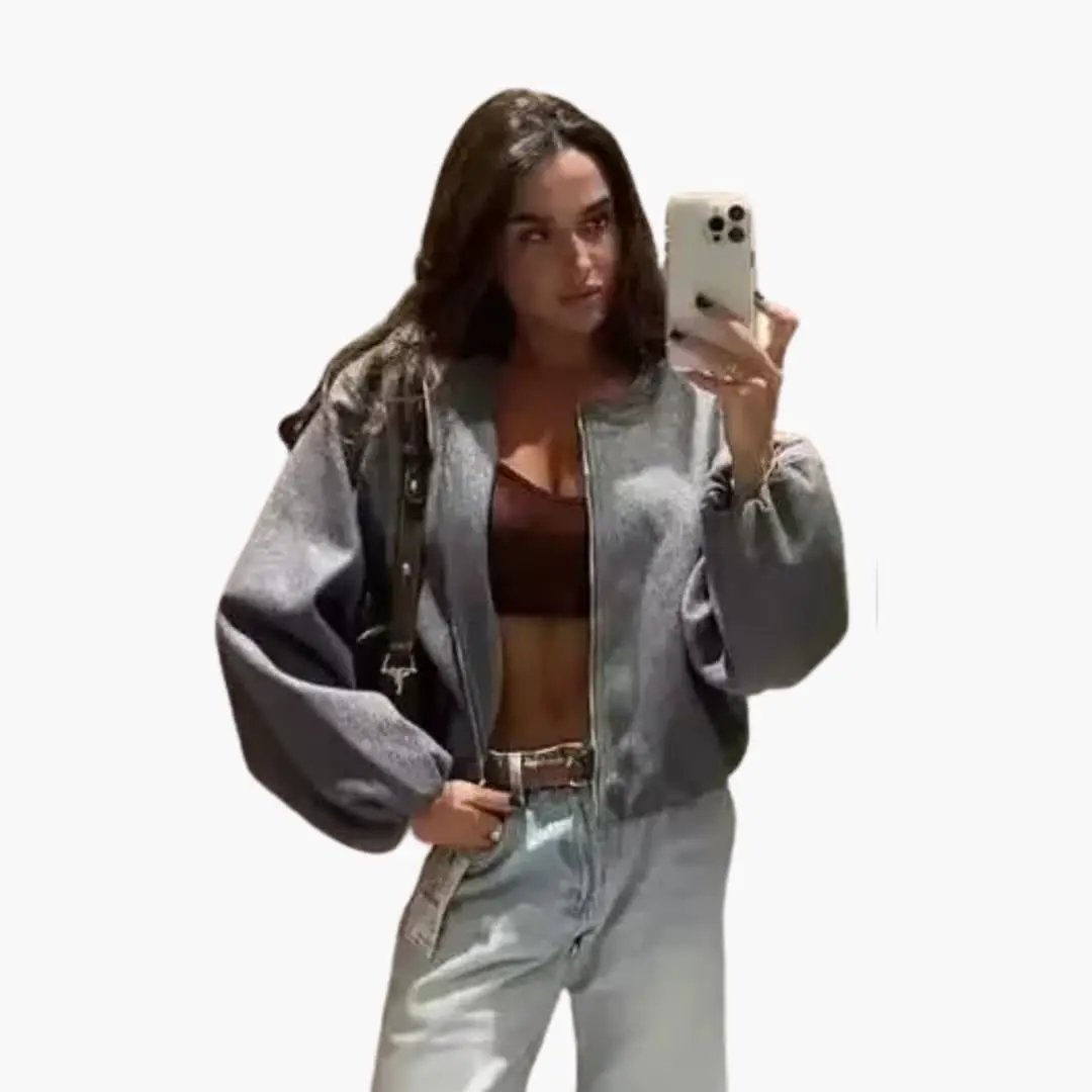 Women’s gray bomber jacket with zip closure and oversized puff sleeves, worn open over a brown top.