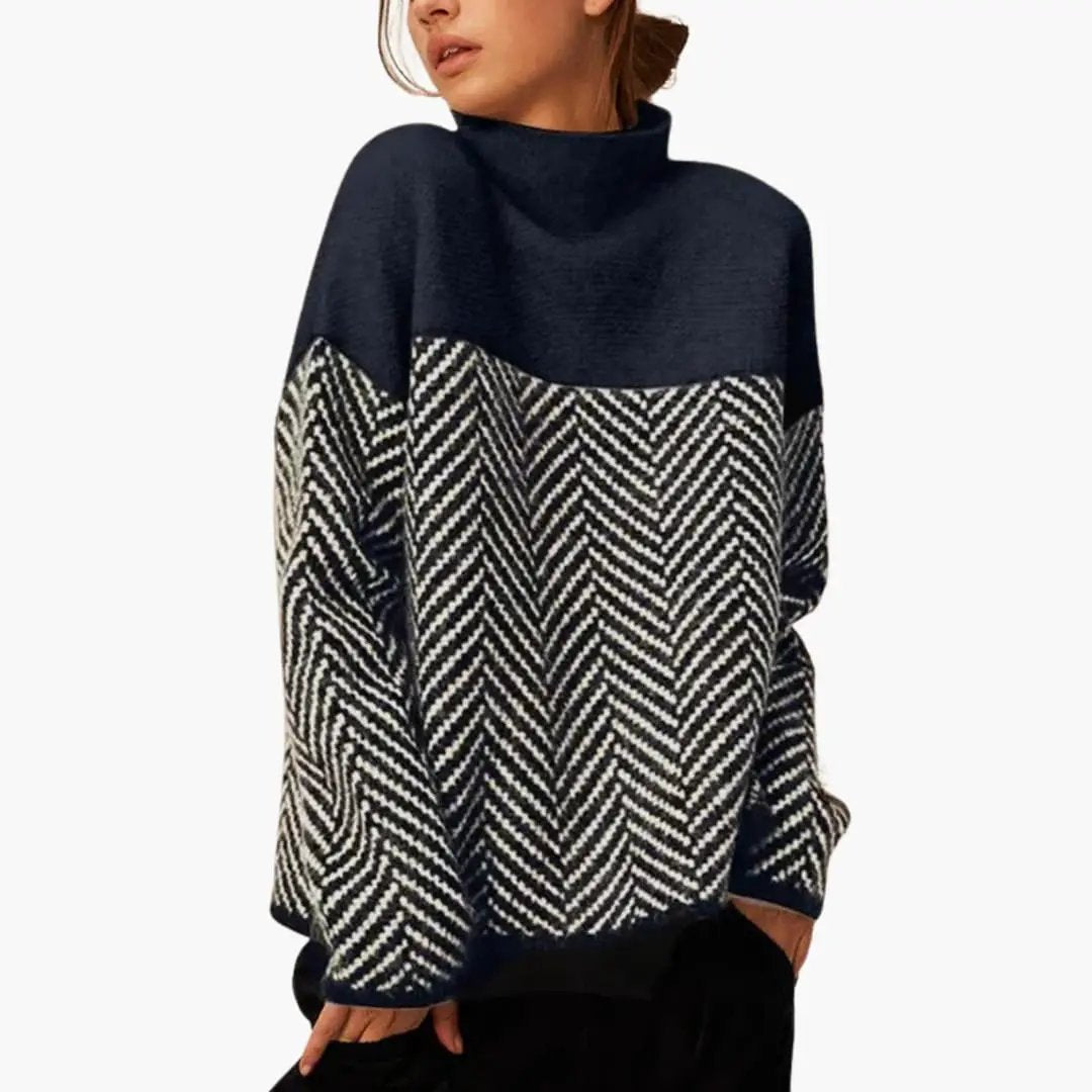 Women's knit sweater with stand collar; navy upper, black-and-white chevron patterned lower panel.