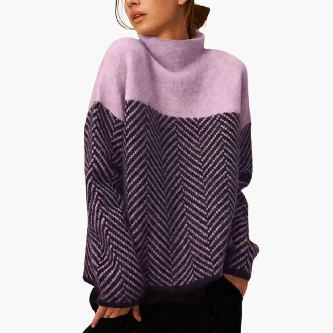 Women's knit sweater with stand collar featuring lavender upper with dark purple chevron-patterned lower half.