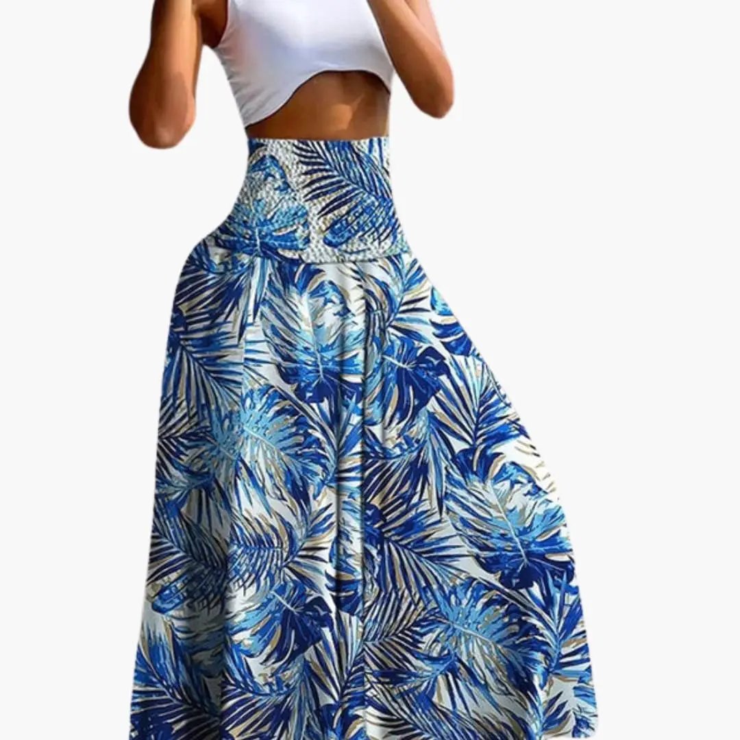 Women's long A-line skirt with elastic waistband and side pockets in a blue tropical leaf print.