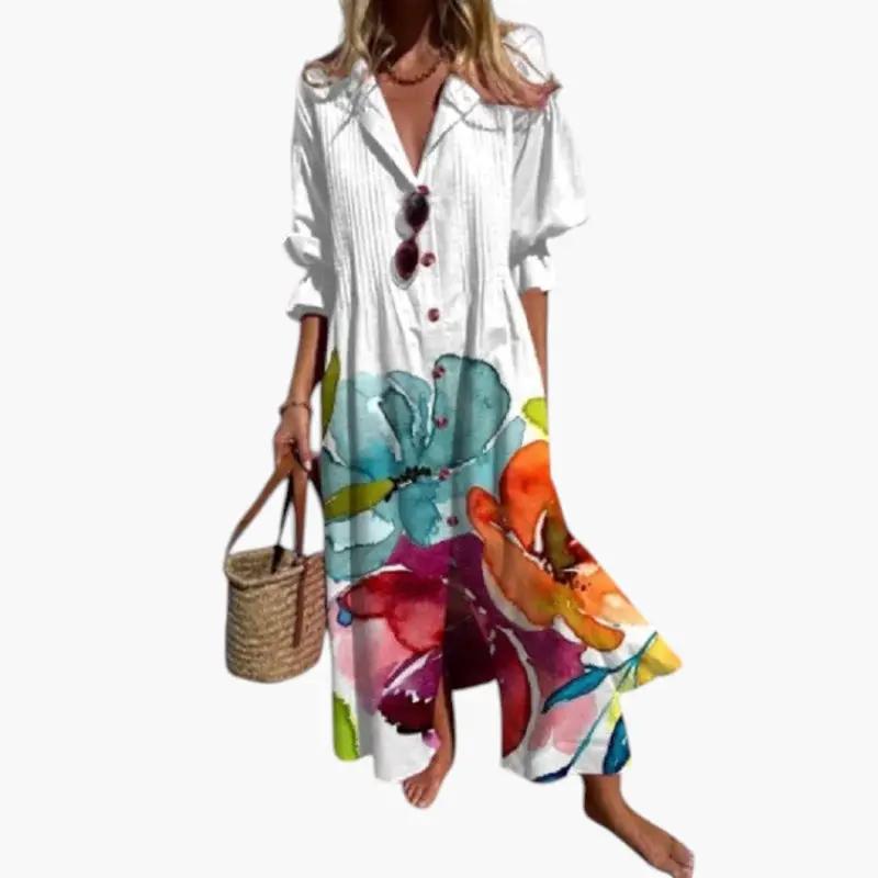 Women's maxi dress with white bodice and bold floral pattern at the hem and pockets