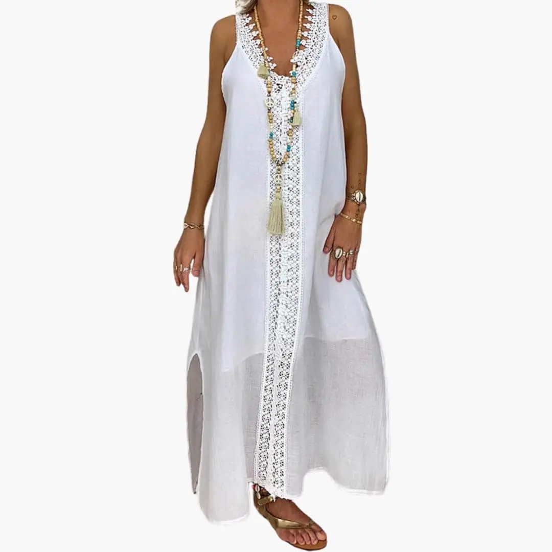 Women's Maxi Dress by Wilfred Smith in white with lace trim and side slits.