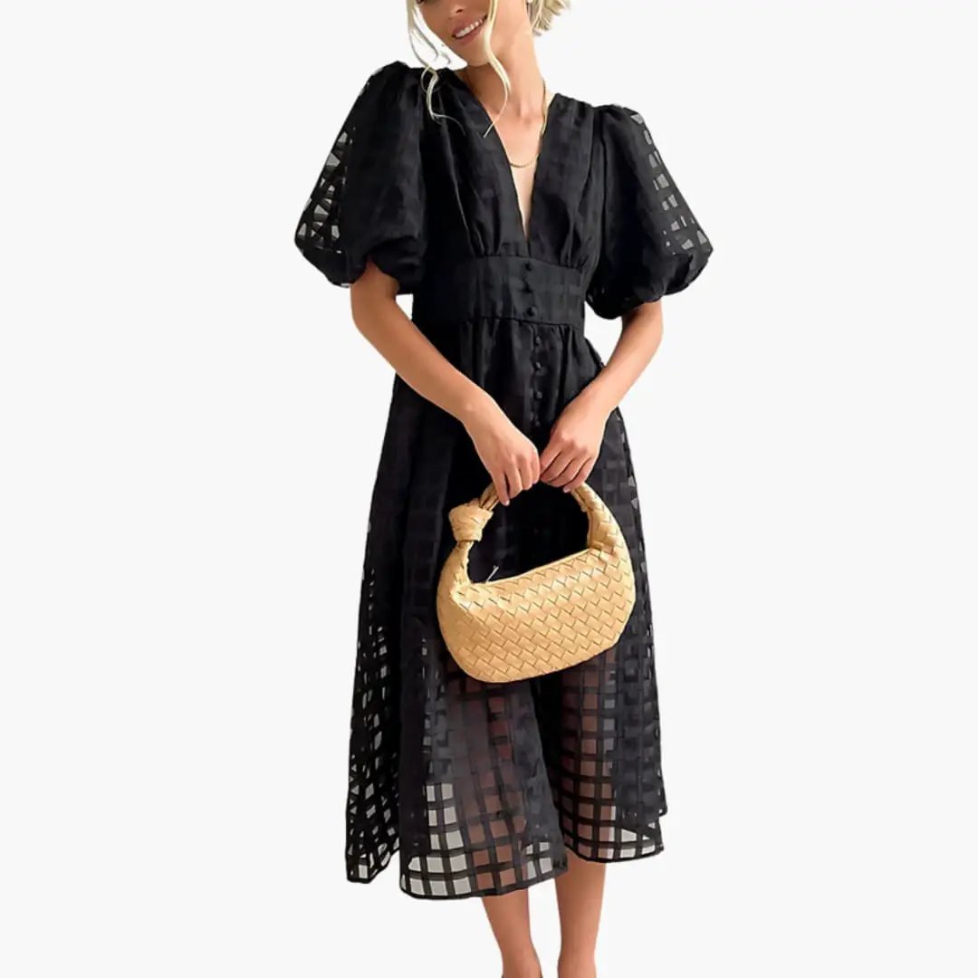 Women’s black midi dress with defined waist and puff sleeves; sheer checkered overlay and flowing silhouette.