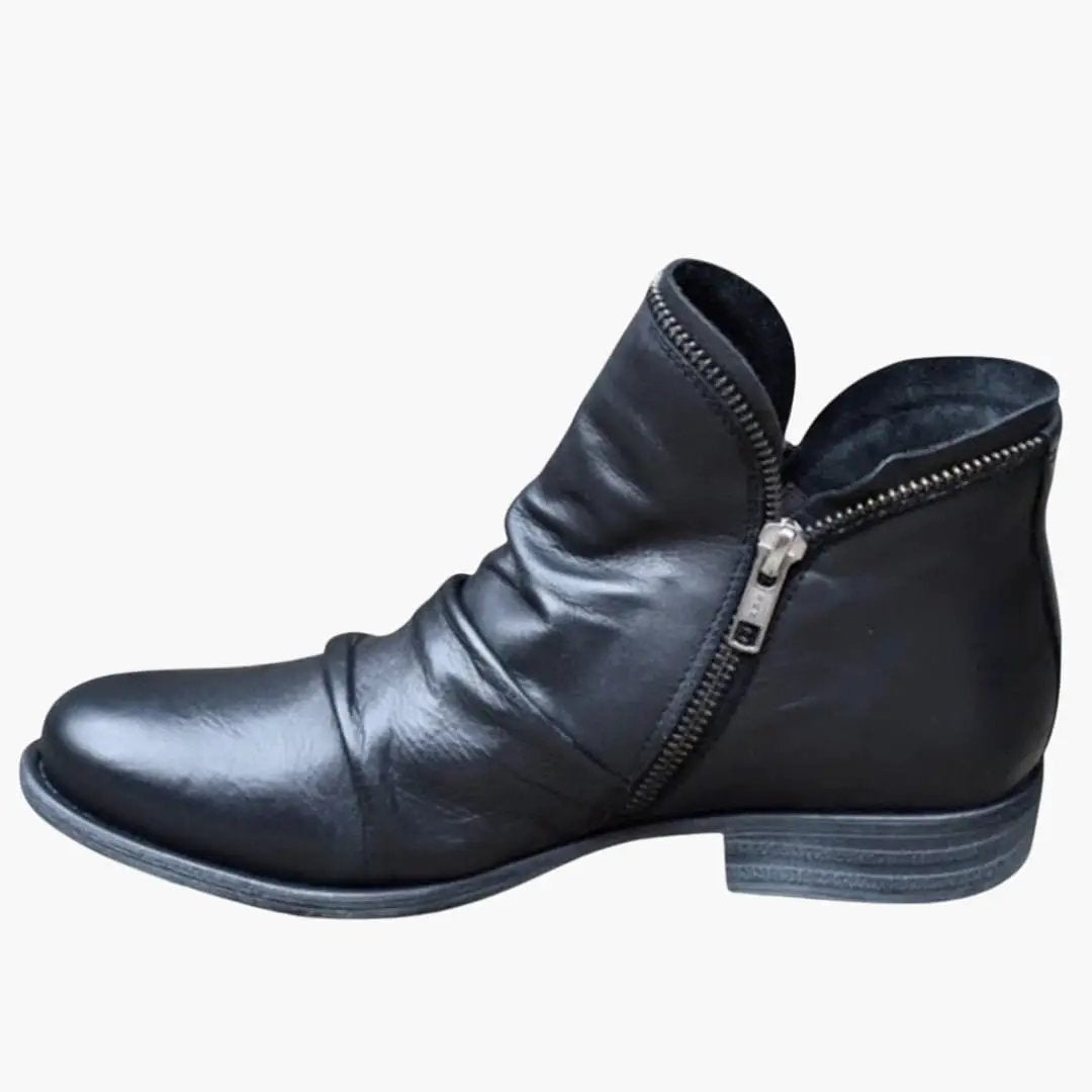 Women's orthopedic ankle boot in black leather with cushioned interior and side zipper, textured sole