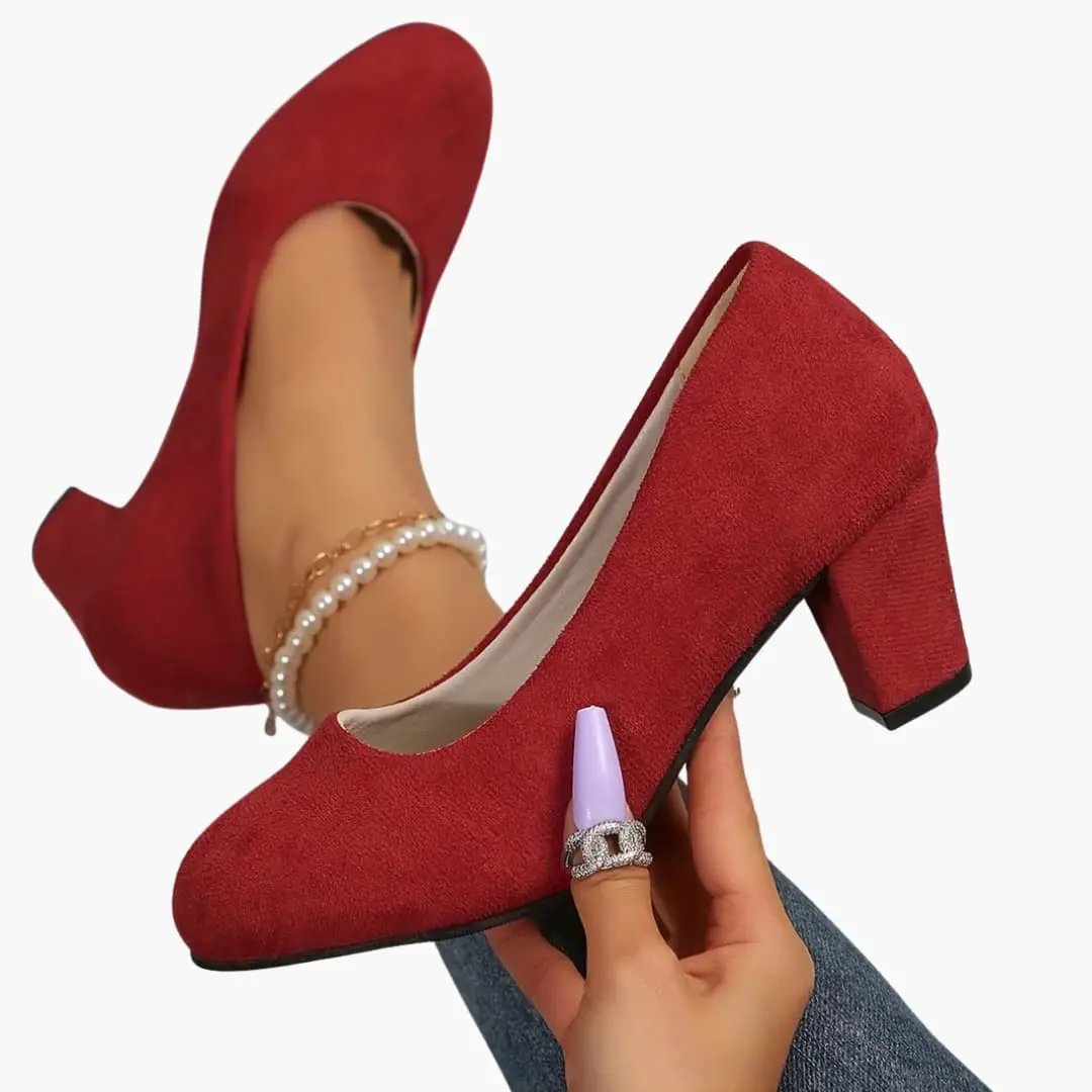 Pair of women's orthopedic heels by Wilfred Smith, red suede pumps with a wide toe box, cushioned insole, block heel.