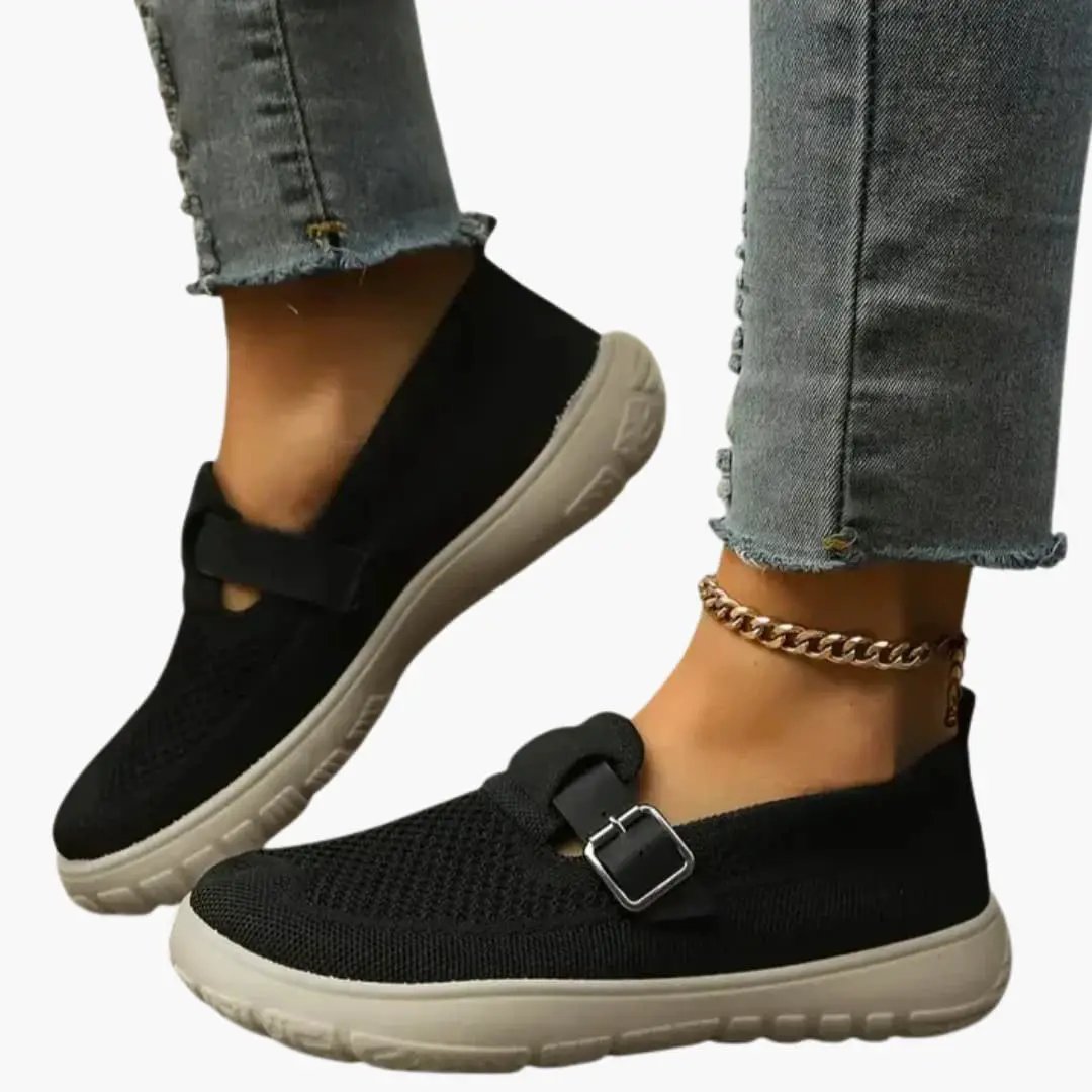 Orthopedic women's loafers, pair of black knit flats with adjustable strap and beige textured sole