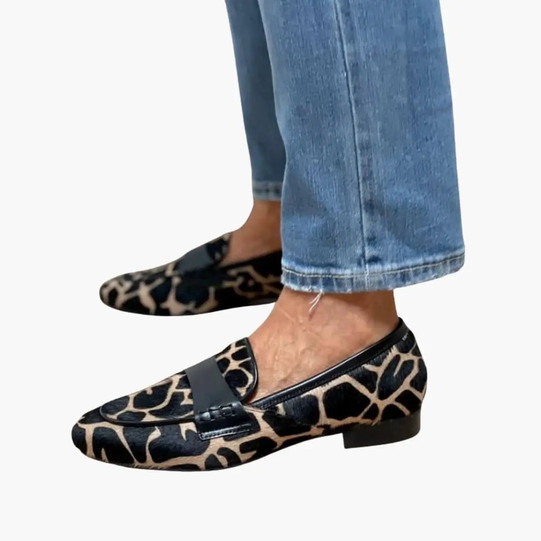 Pair of women's orthopedic loafers in leopard print slip-on flats with cushioned insole.