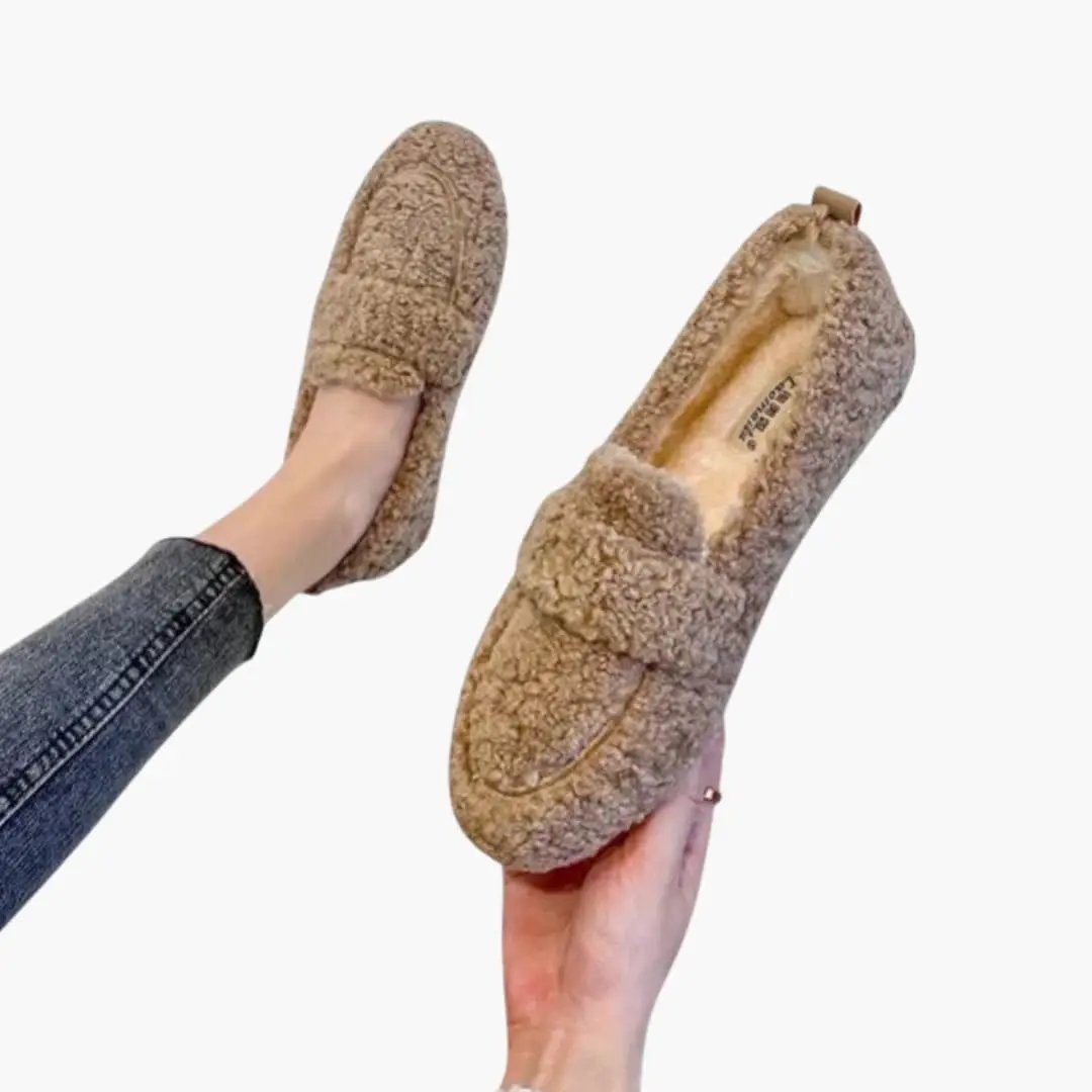 a pair of women's orthopedic slip-on flats in beige fuzzy shearling with rubber sole