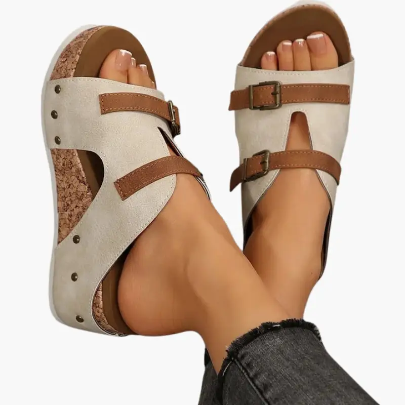 Pair of women’s orthopedic sandals with wedge sole and beige uppers, brown adjustable straps
