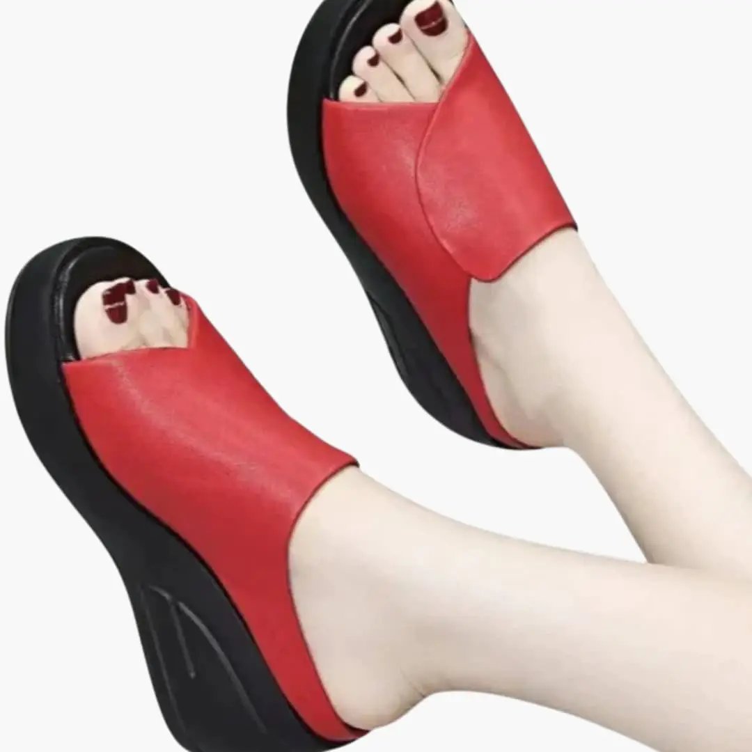 Pair of women's orthopedic sandals with red upper, wedge sole, slip-on design