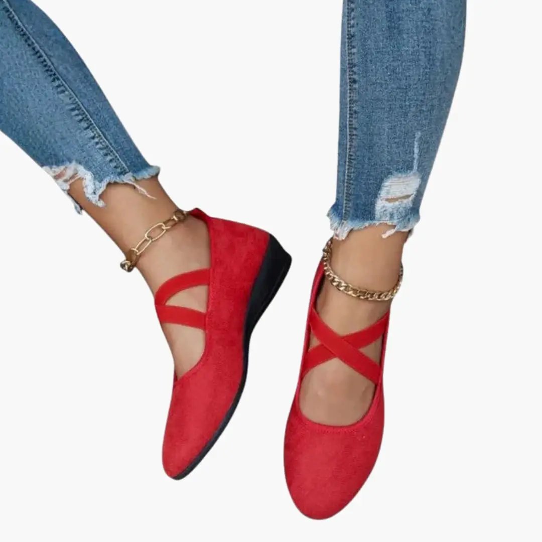 Women's orthopedic flats with red criss-cross straps, slip-on design and cushioned sole