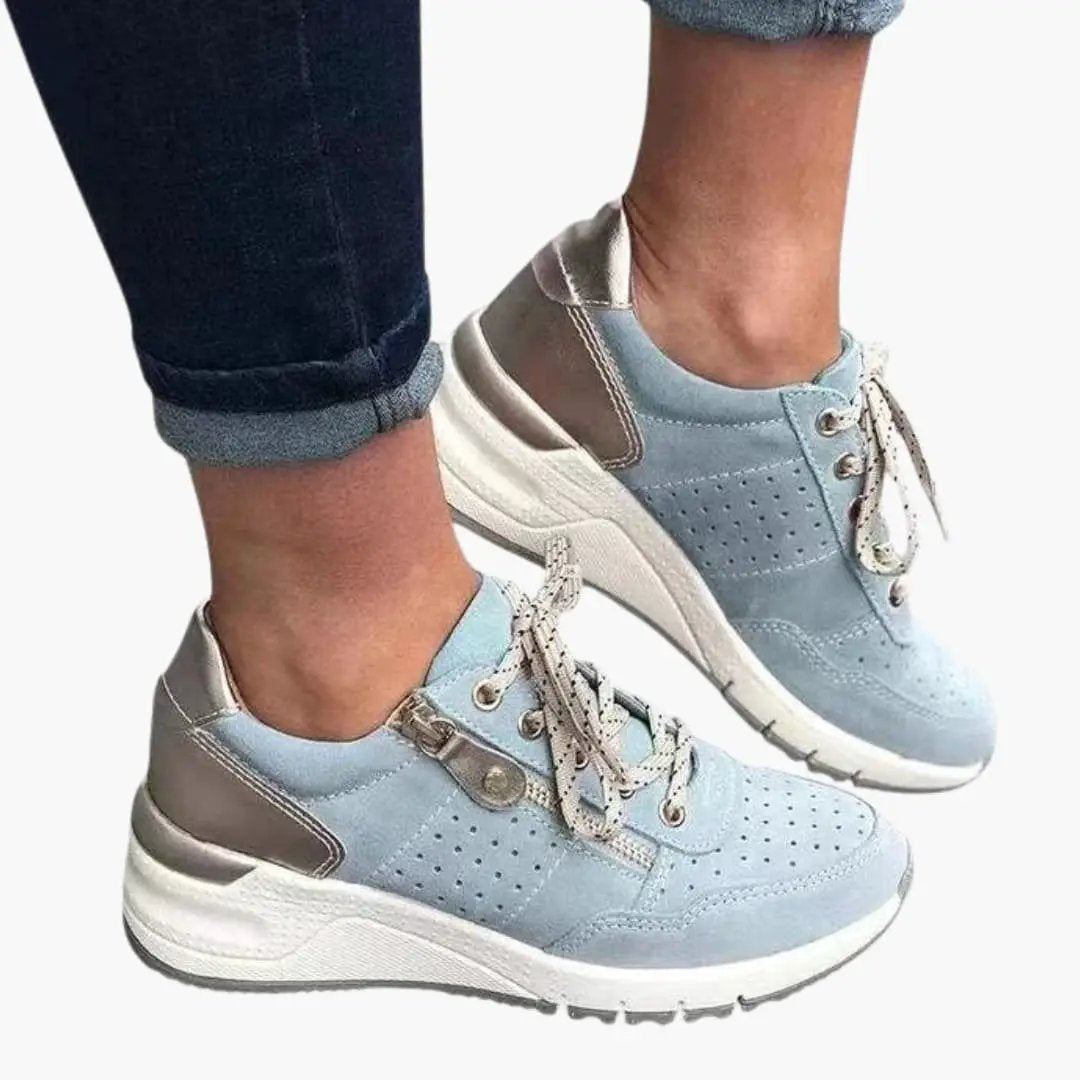 Women's orthopedic sneakers, light blue with perforated panels, cushioned lining and textured sole.