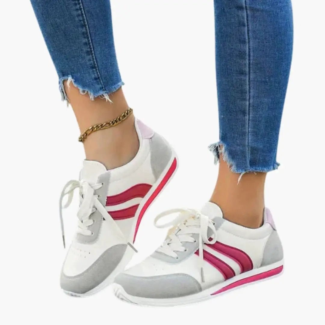 Women's orthopedic athletic shoes by Wilfred Smith, breathable upper, rubber sole, white with pink stripes.