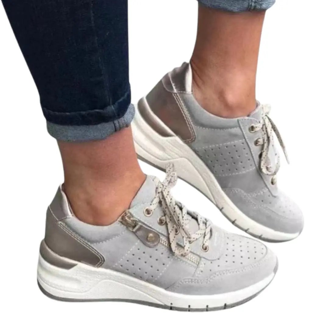 Women's orthopedic sneakers with cushioned sole and lace closure by Wilfred Smith, light gray perforated suede upper.
