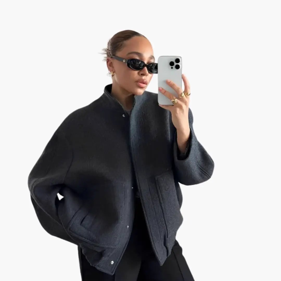 Women's oversized bomber jacket with snap buttons and pockets in dark gray.
