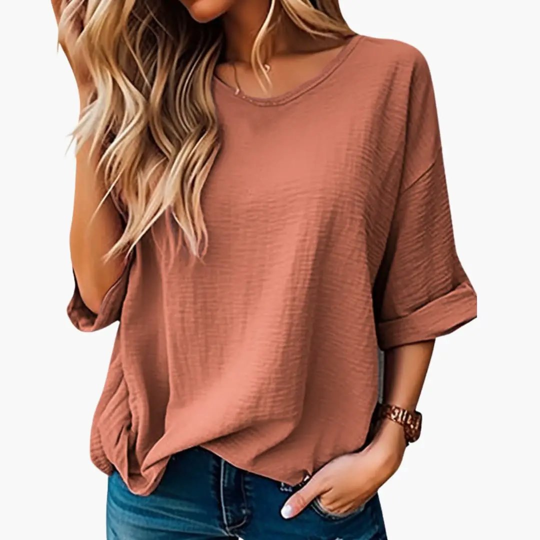 Women's oversized textured crew-neck short-sleeve T-shirt in dusty rose, with rolled sleeves.
