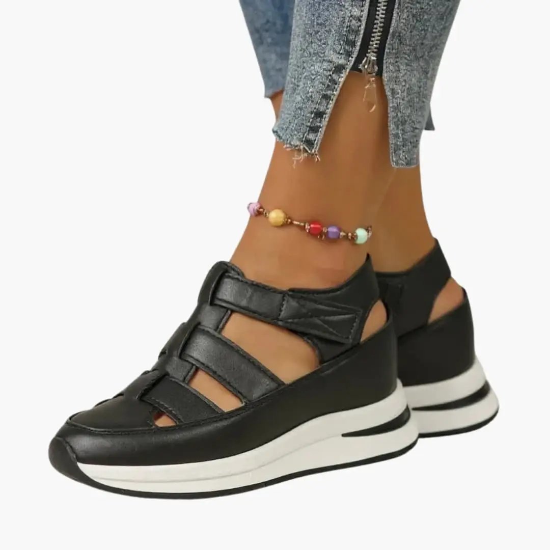 Wilfred Smith women's platform sandals with adjustable straps, cushioned sole, black leather uppers and white platform.