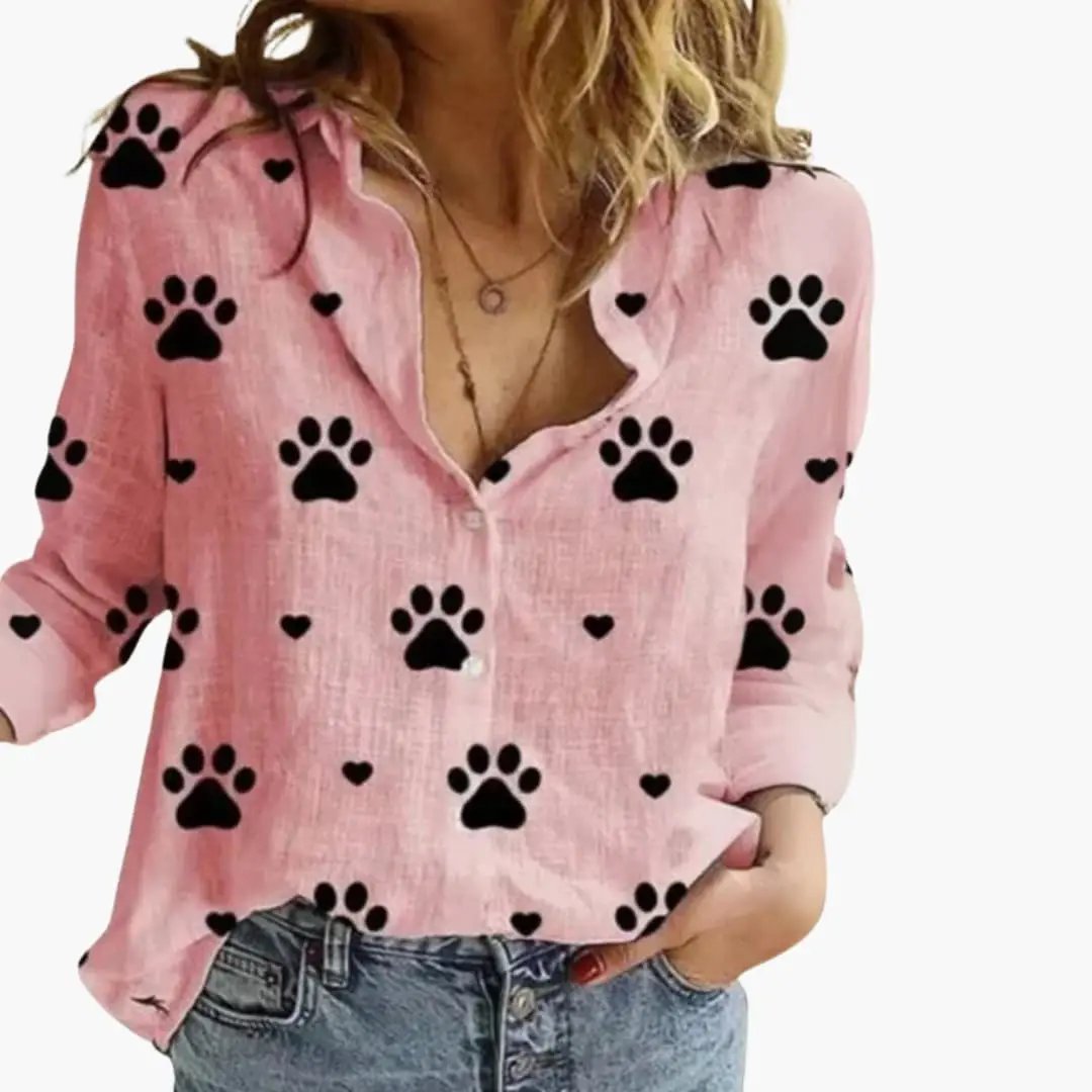 Women's pink woven blouse with black paw prints and small heart accents, long sleeves