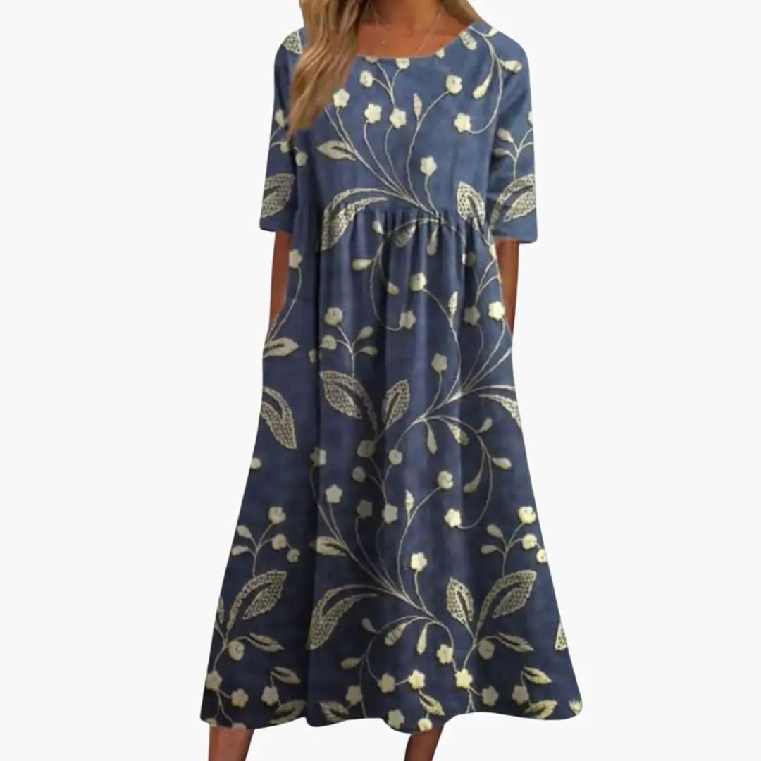 Women’s printed midi dress by Wilfred Smith, blue floral pattern, short sleeves, loose fit.