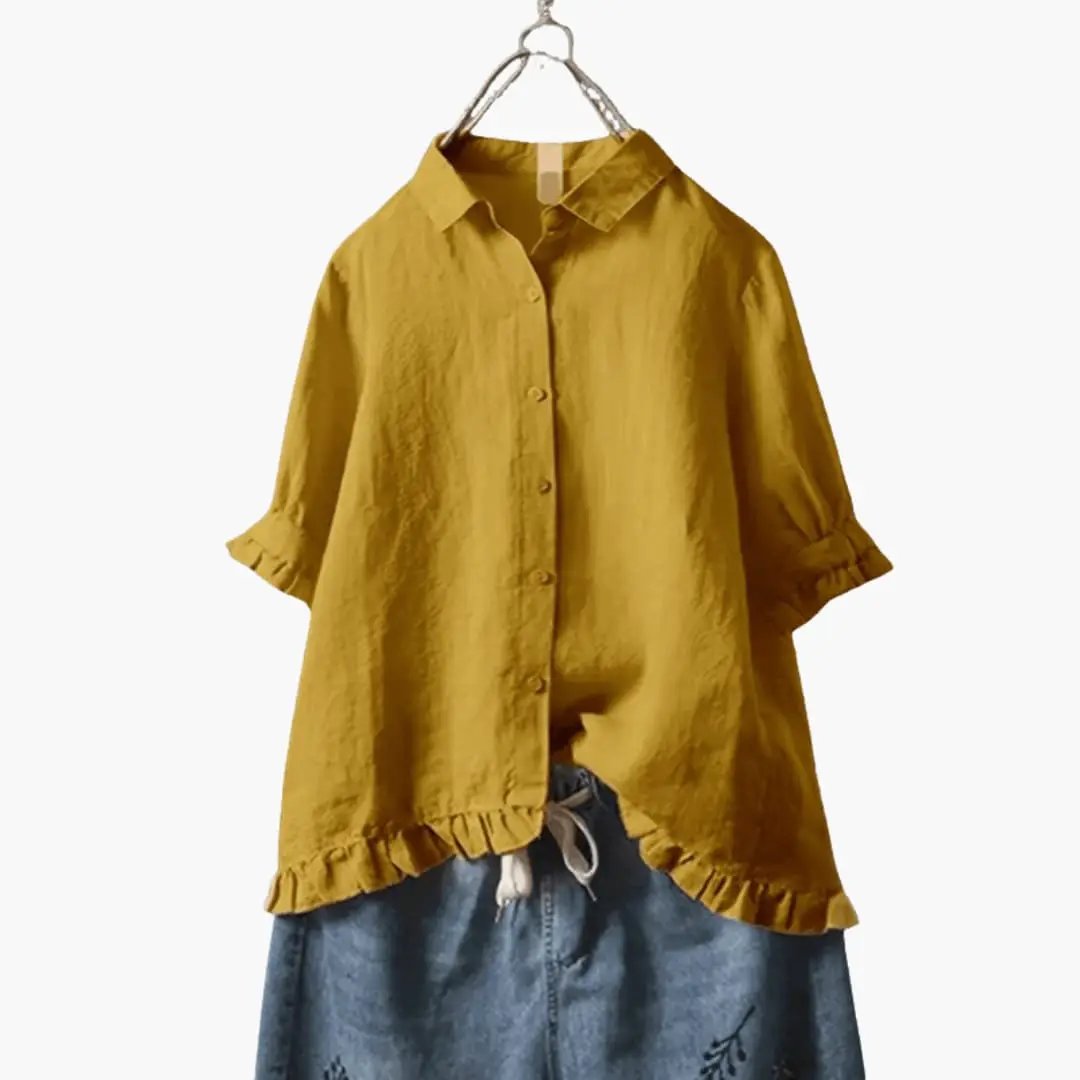 Women's relaxed-fit blouse in mustard yellow with long sleeves, button-down front and ruffled hem