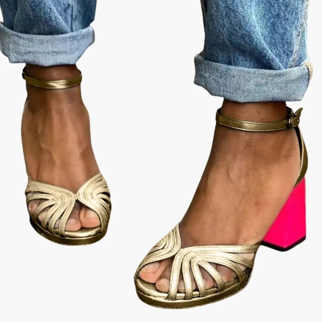 Wilfred Smith women's sandals with ankle strap and block heel, metallic gold open-toe straps and pink heel.