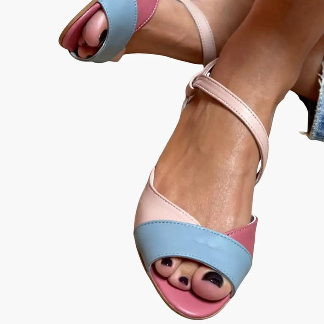 Wilfred Smith women's sandals with pastel blue and pink asymmetrical straps and a cushioned insole.