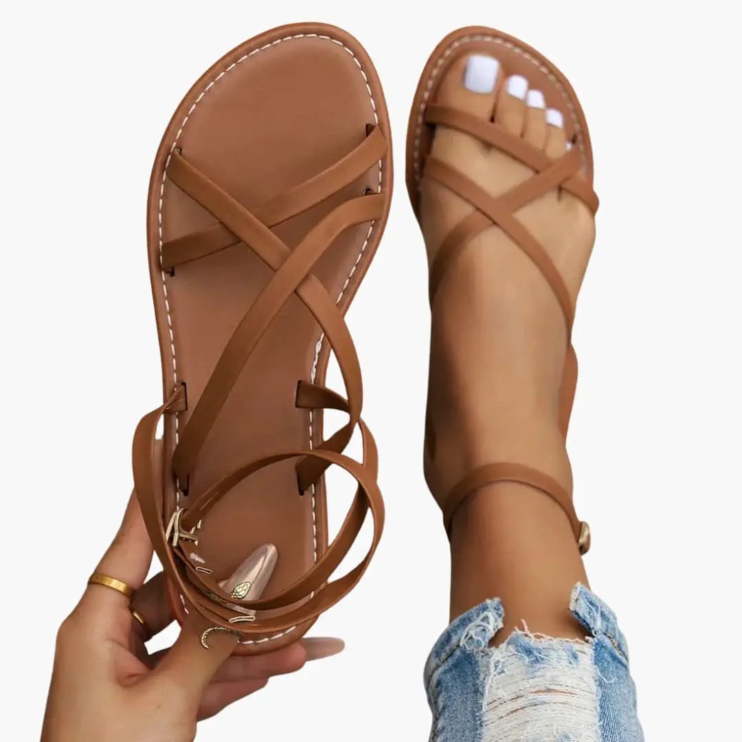 Women's sandals by Wilfred Smith with crisscross straps and adjustable ankle strap in tan leather