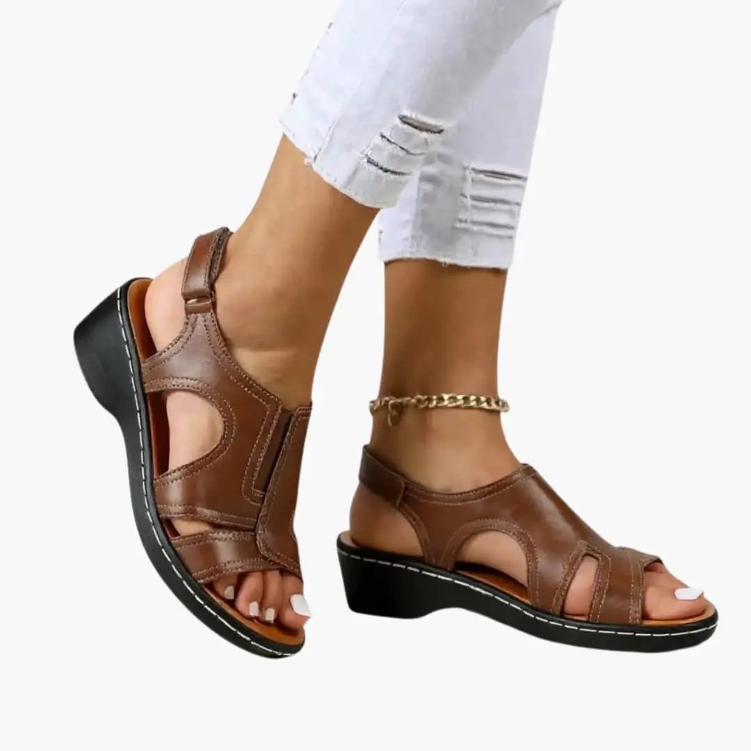 Women's brown leather sandals with cushioned insole and adjustable strap, wedge heel.