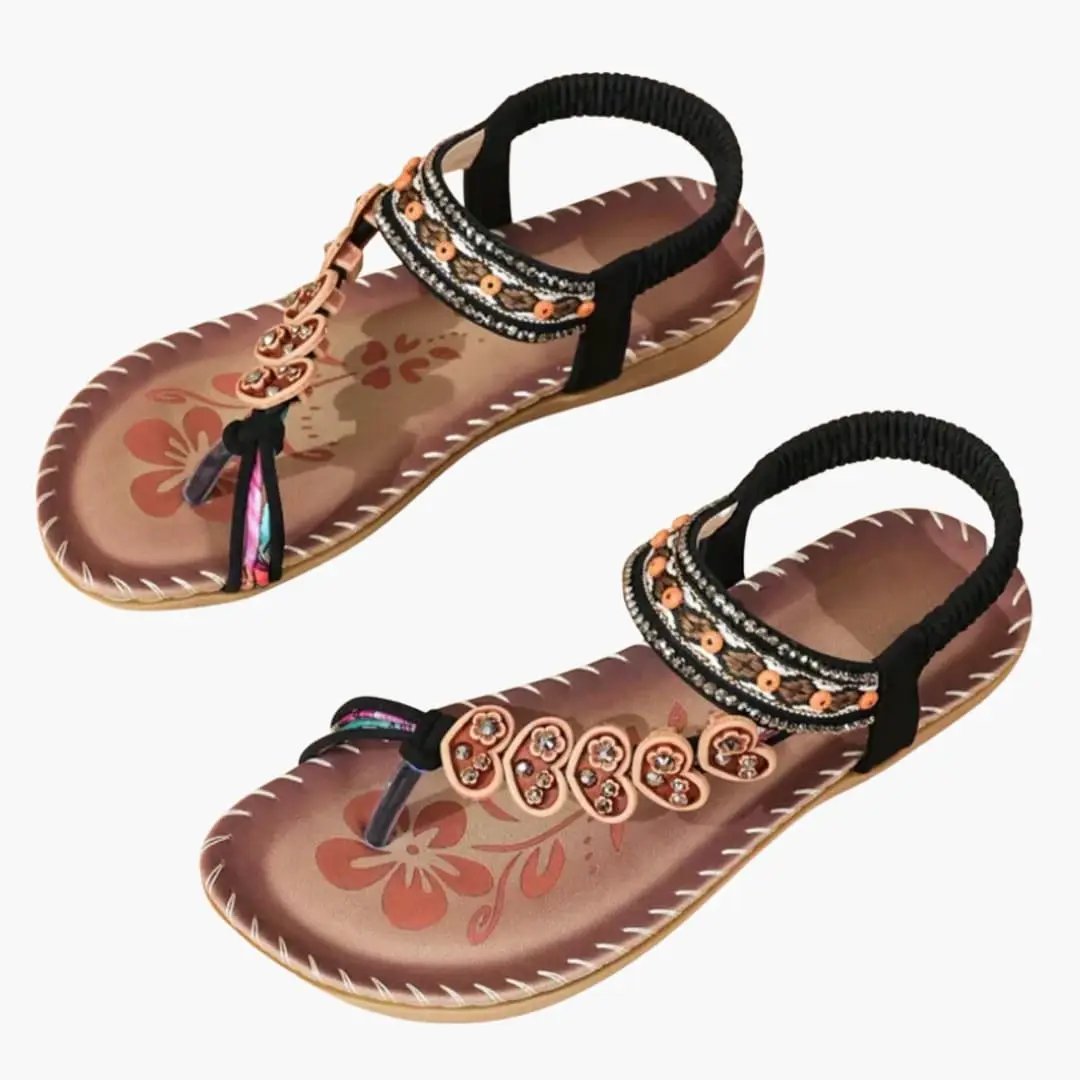 Pair of Wilfred Smith women's sandals with slip-on design, open toe, beaded embellished straps and floral footbed.