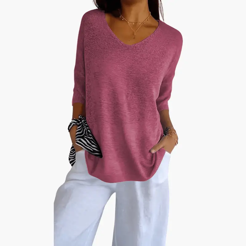Women’s short sleeve V-neck pullover top in pink heather, shown with white pants