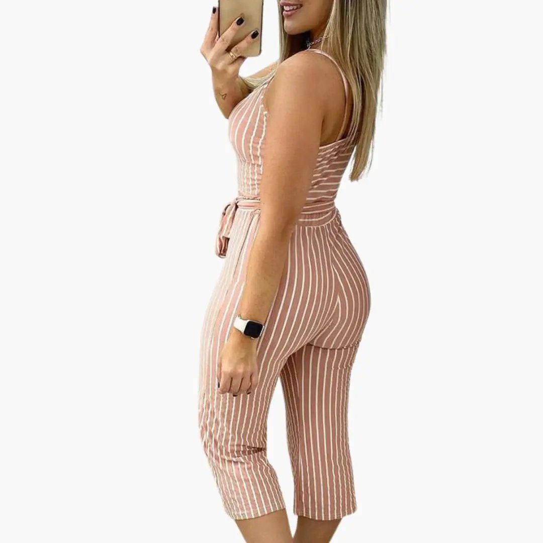 Women's sleeveless vertical stripe jumpsuit with waist belt in blush pink with white stripes, cropped-leg length.