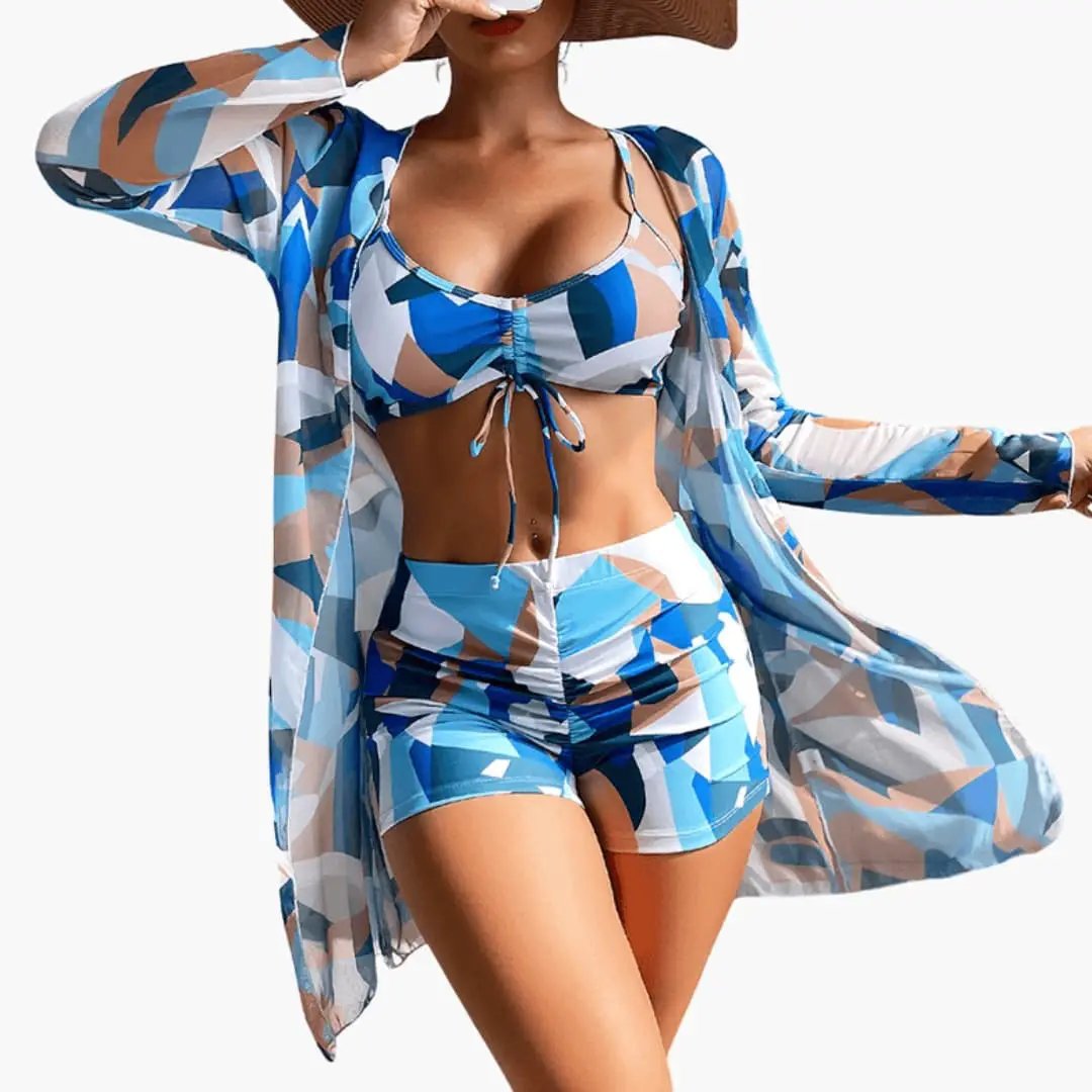 Women’s three-piece bikini set with a V-neck tie-dye top, matching blue bottoms, and sheer cover-up.