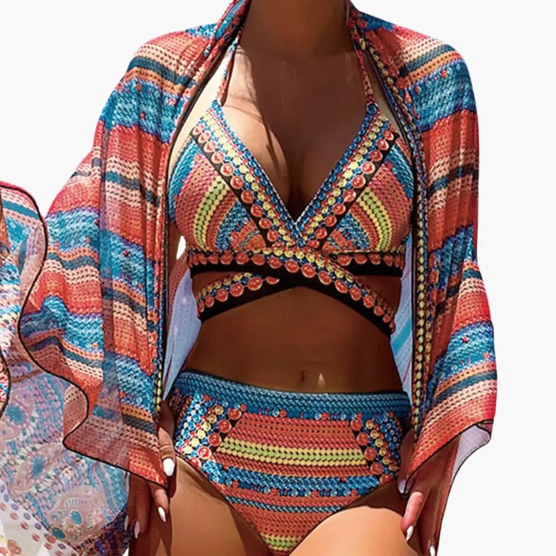 Women’s three-piece high-waisted bikini set with cross-strap back and sheer cover-up in vibrant print by Wilfred Smith.