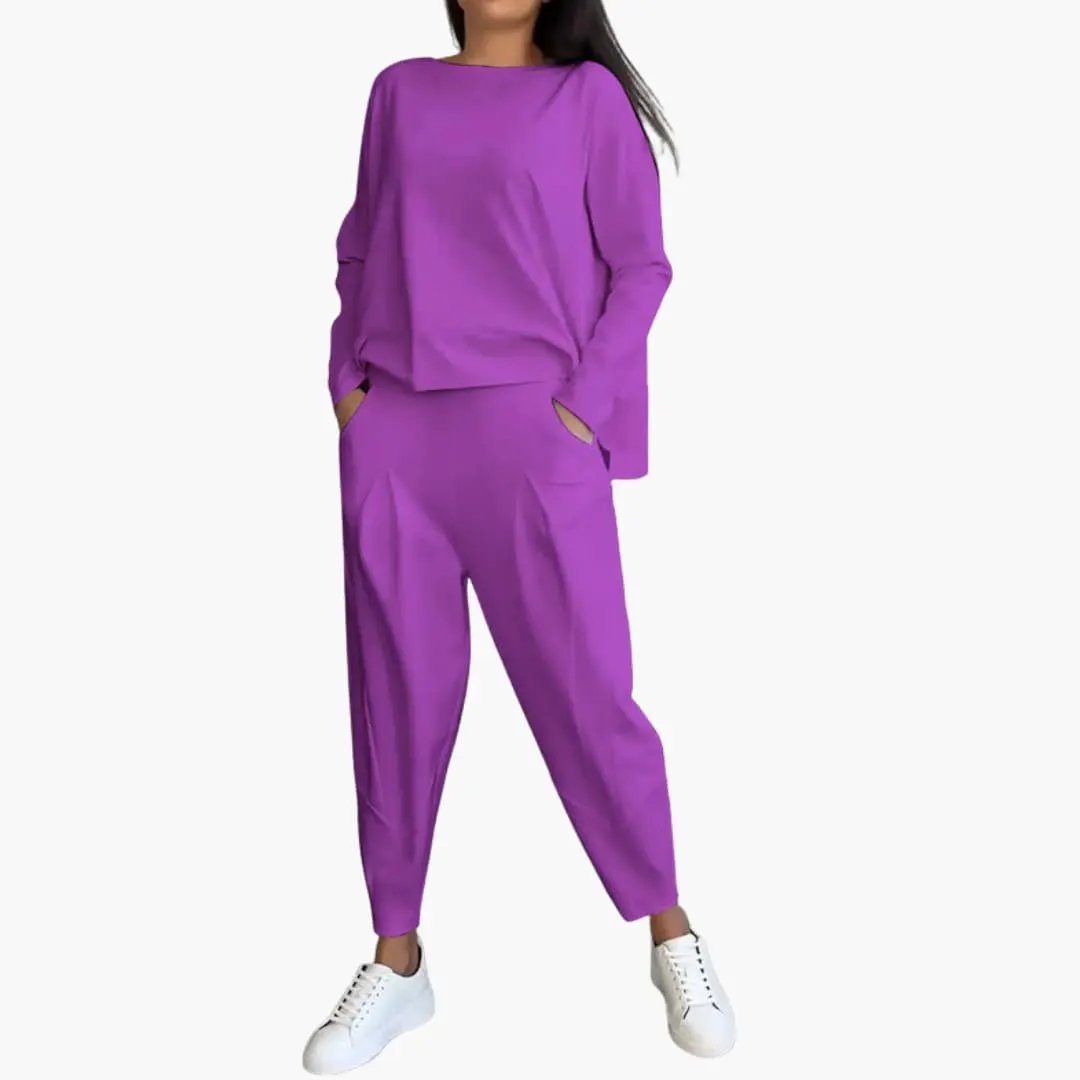 Women's two-piece outfit set in purple with a round-neck top and matching tapered trousers.