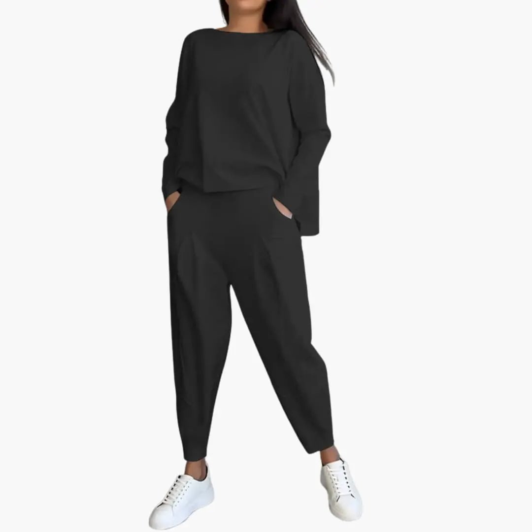 Women's two-piece outfit by Wilfred Smith: black round-neck top and matching tapered pants with pockets.